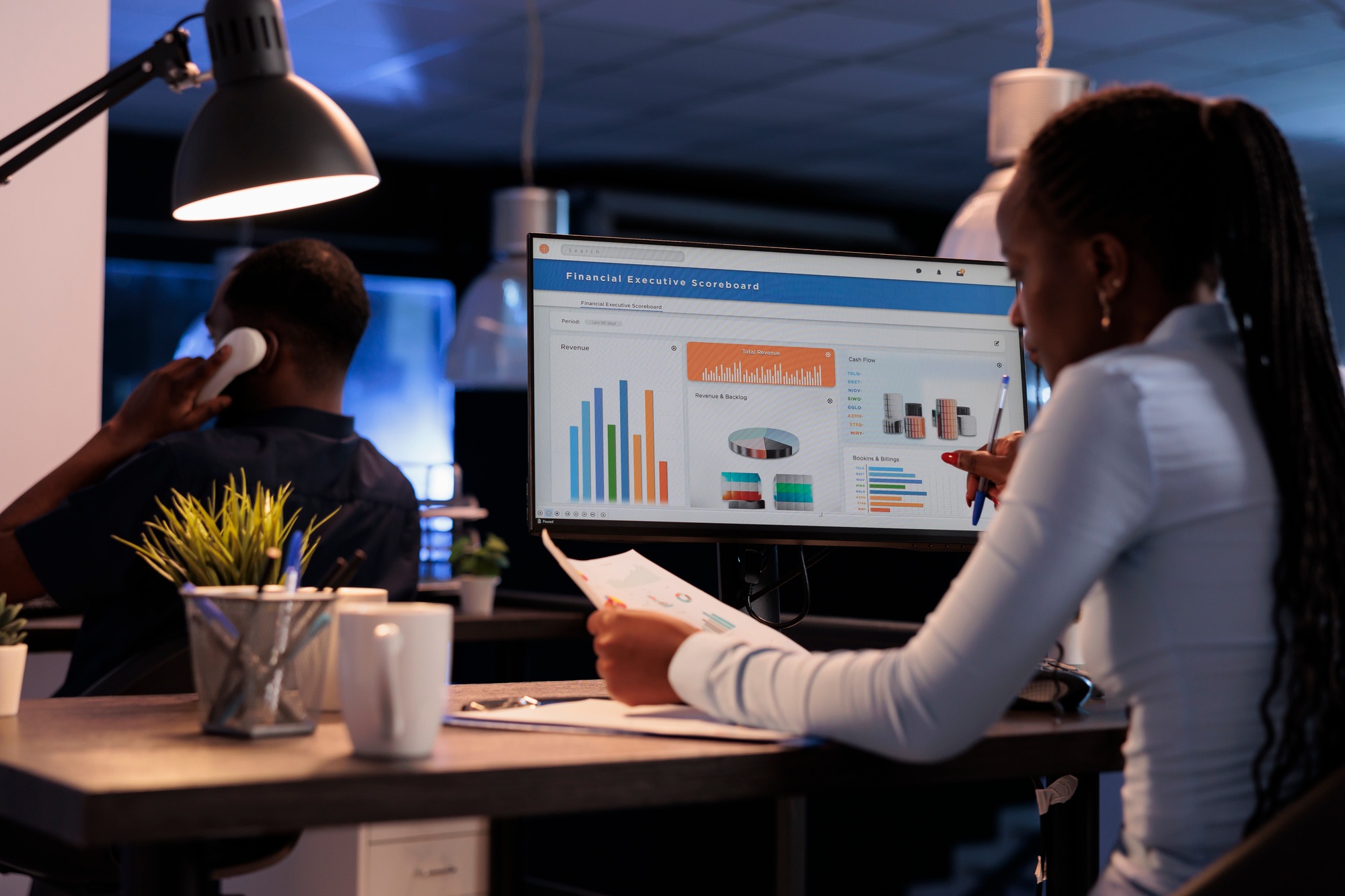 http://African%20american%20woman%20analyzing%20business%20charts%20on%20computer